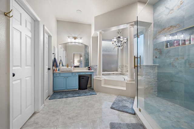 bathroom featuring tile patterned flooring, a garden tub, vanity, a stall shower, and ornate columns