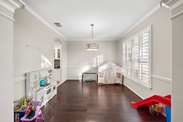 rec room featuring ornamental molding, dark wood-style flooring, and visible vents