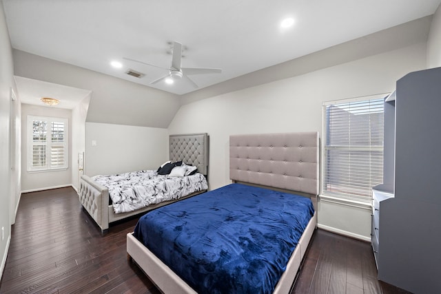 bedroom with baseboards, visible vents, vaulted ceiling, and dark wood-type flooring