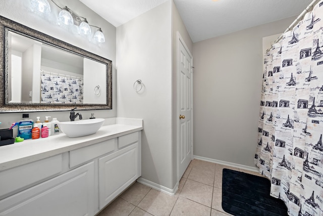 bathroom with a shower with curtain, vanity, baseboards, and tile patterned floors