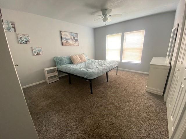 bedroom with baseboards, dark carpet, and ceiling fan