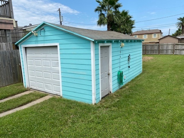 detached garage with driveway and fence