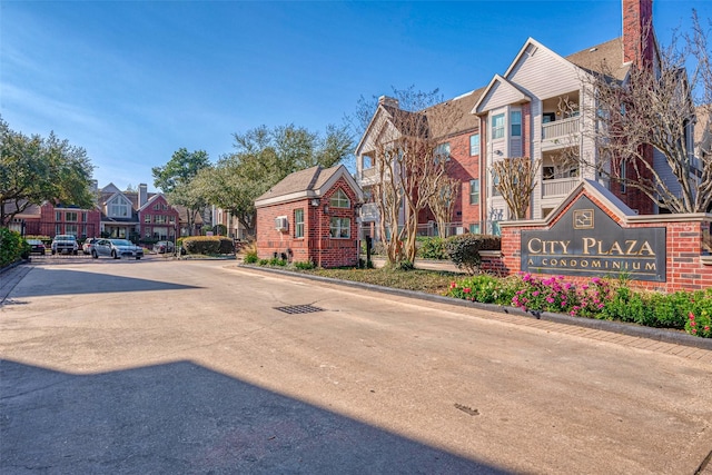 view of street with a residential view and curbs