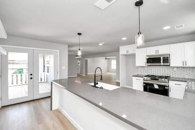 kitchen featuring appliances with stainless steel finishes, french doors, visible vents, and white cabinets