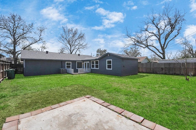 back of house featuring a yard, central AC unit, a patio area, and a fenced backyard