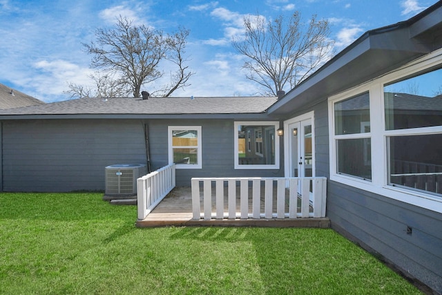 property entrance featuring central AC, a lawn, and a wooden deck