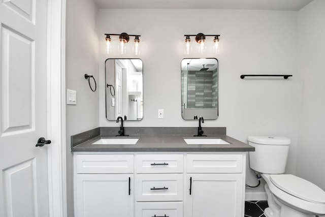 full bathroom with tile patterned flooring, a sink, toilet, and double vanity