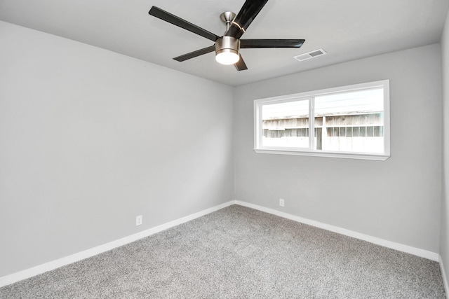 spare room with a ceiling fan, carpet, visible vents, and baseboards