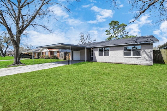 view of front of property with an attached carport, concrete driveway, fence, and a front yard