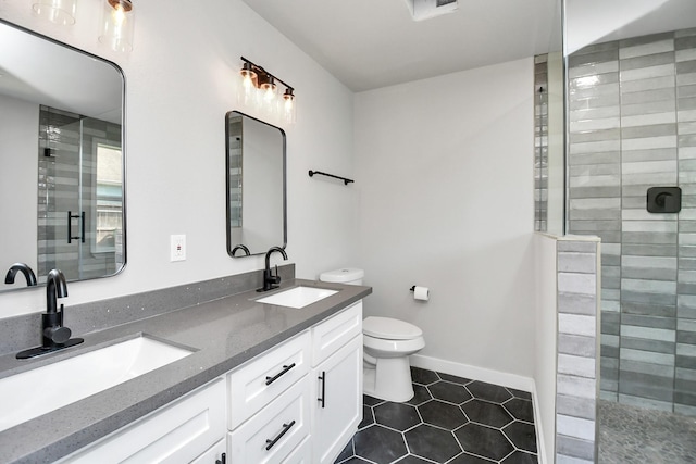 full bath with toilet, double vanity, a sink, and tiled shower