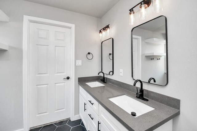 bathroom featuring double vanity, a sink, and tile patterned floors