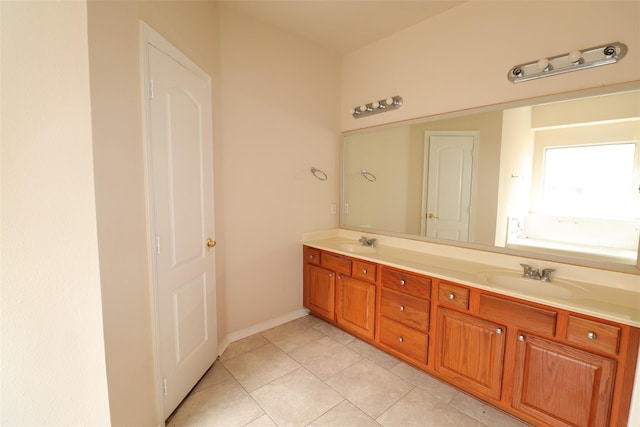 full bathroom featuring double vanity, a sink, and tile patterned floors