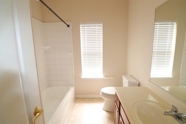 bathroom with shower / tub combination, vanity, toilet, and baseboards