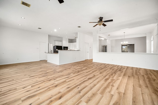 unfurnished living room featuring light wood-style floors, recessed lighting, visible vents, and ceiling fan with notable chandelier