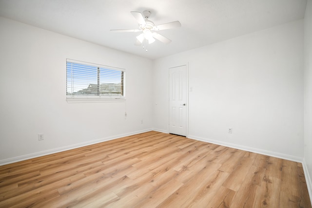 empty room with light wood-type flooring, ceiling fan, and baseboards