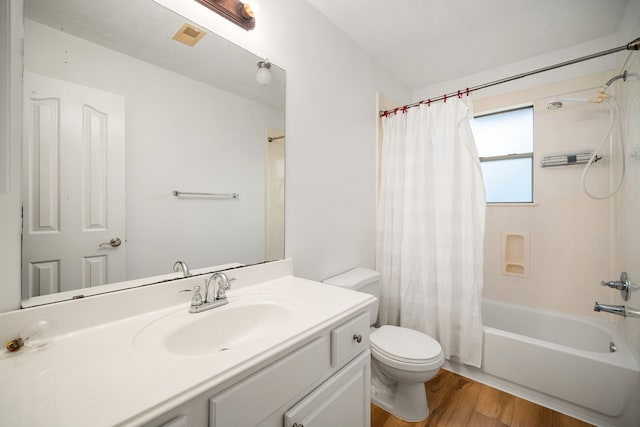 full bath with visible vents, toilet, wood finished floors, shower / bath combination with curtain, and vanity