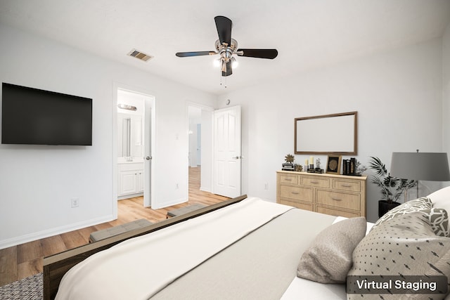 bedroom with ceiling fan, visible vents, baseboards, light wood-type flooring, and ensuite bath