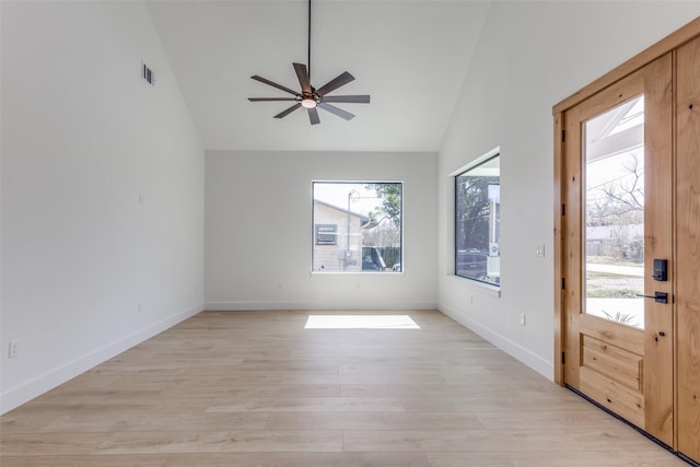 entrance foyer featuring baseboards, a ceiling fan, vaulted ceiling, and light wood finished floors