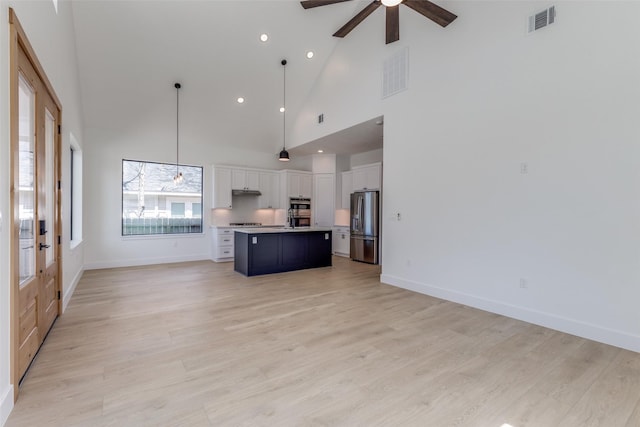 unfurnished living room with visible vents, light wood-style flooring, and a ceiling fan