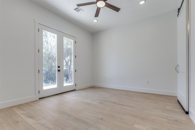 empty room featuring light wood-style flooring, plenty of natural light, french doors, and ceiling fan