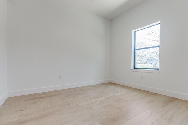 empty room with light wood-style flooring and baseboards