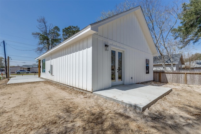 back of property featuring a patio, french doors, board and batten siding, and fence