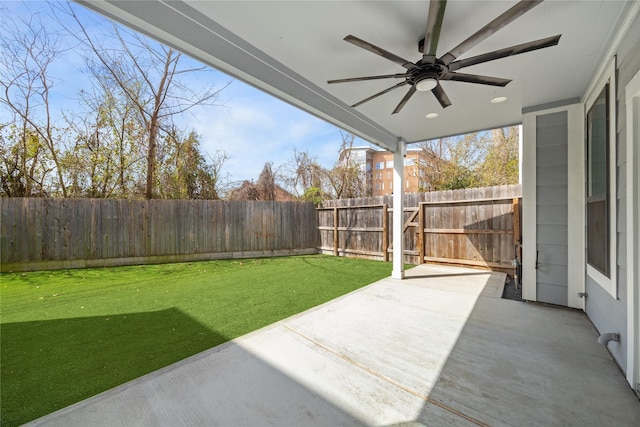 view of yard with a patio, a gate, a ceiling fan, and a fenced backyard