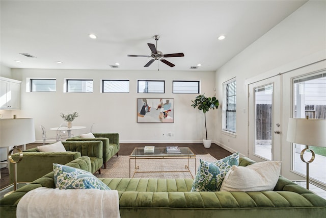 living area featuring recessed lighting, visible vents, and baseboards