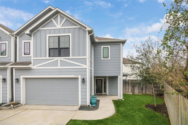 view of front of house featuring fence, driveway, a front lawn, a garage, and board and batten siding