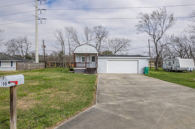 view of front of home featuring driveway, a front lawn, and an attached garage