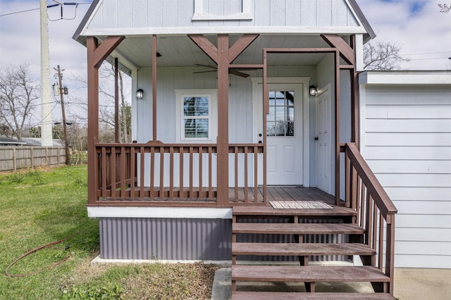 property entrance with a lawn and fence