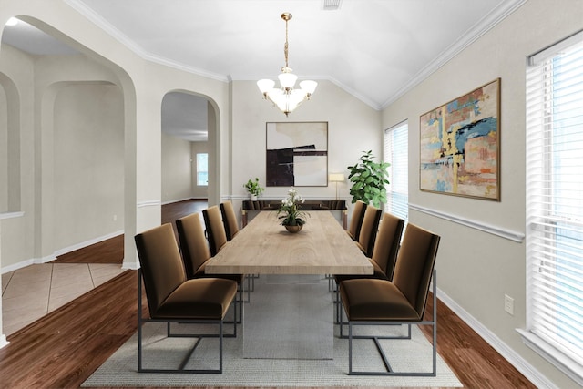 dining area featuring dark wood-style floors, a healthy amount of sunlight, and crown molding