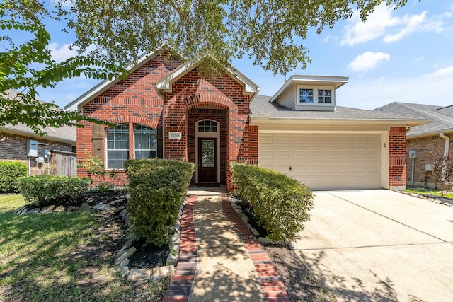 traditional home featuring a shingled roof, brick siding, driveway, and an attached garage