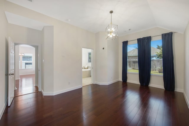 spare room with baseboards, arched walkways, vaulted ceiling, and dark wood-type flooring