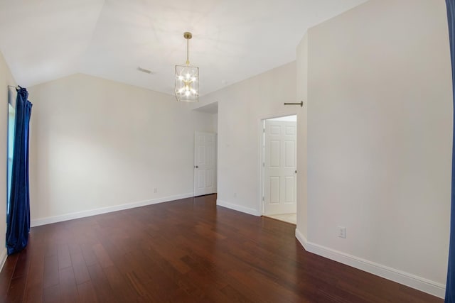 empty room featuring visible vents, baseboards, dark wood finished floors, an inviting chandelier, and vaulted ceiling