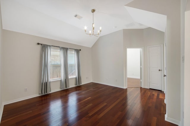 spare room featuring lofted ceiling, a chandelier, dark wood-style flooring, visible vents, and baseboards