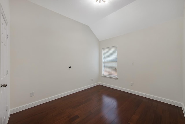 unfurnished room with lofted ceiling, wood finished floors, and baseboards