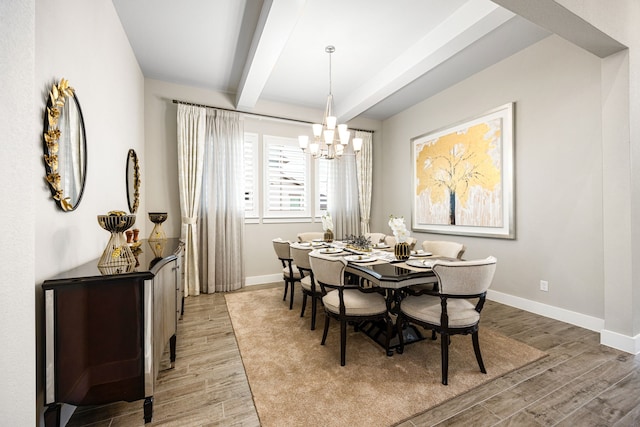 dining room with baseboards, beamed ceiling, and light wood-style floors