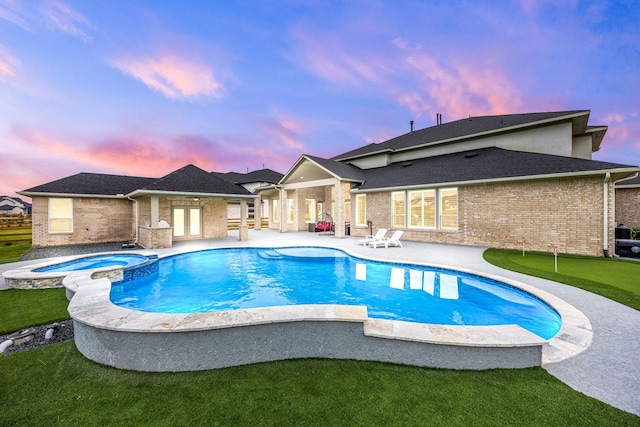 view of swimming pool with a pool with connected hot tub and a patio area