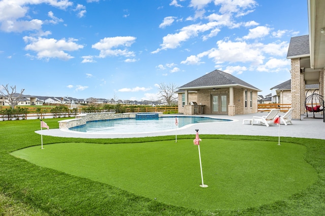 view of swimming pool with a patio, fence, a pool with connected hot tub, a ceiling fan, and a residential view