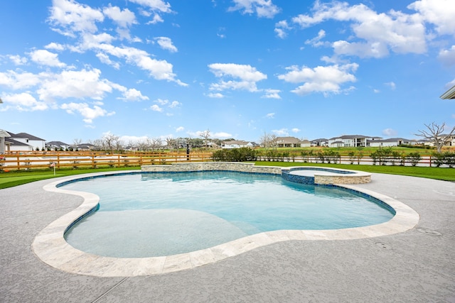 view of pool with a pool with connected hot tub, a residential view, and fence