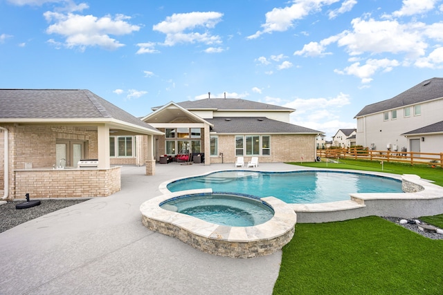 view of pool featuring a lawn, a patio, fence, french doors, and a pool with connected hot tub