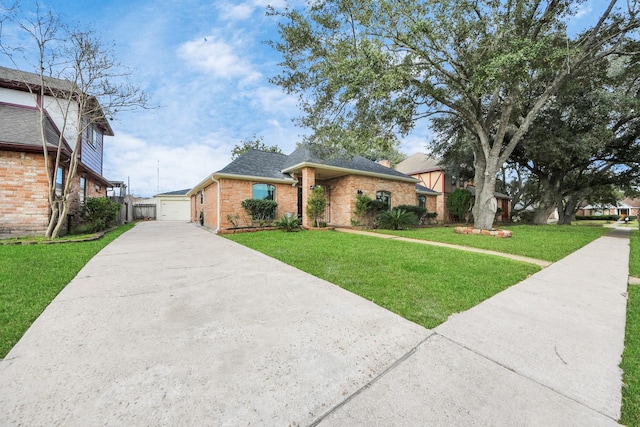 view of front of property with a front lawn, a shingled roof, and brick siding