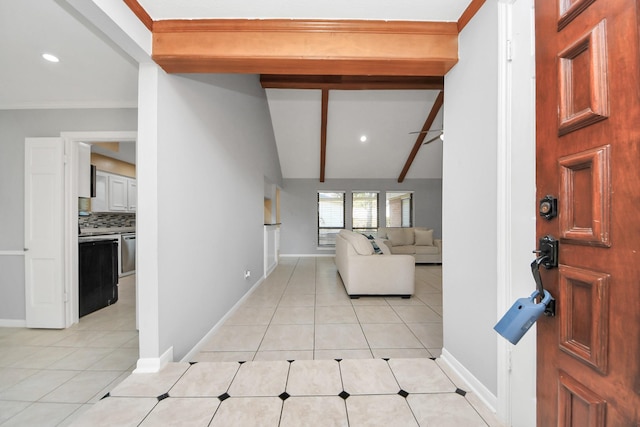 entryway featuring vaulted ceiling with beams, ornamental molding, light tile patterned flooring, and baseboards