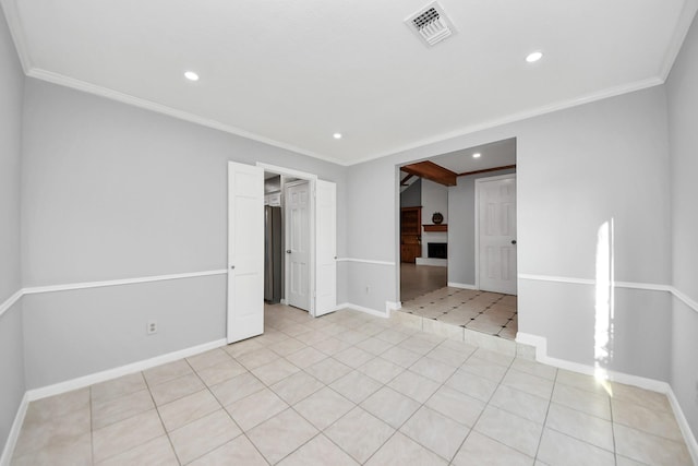 spare room featuring light tile patterned floors, baseboards, visible vents, ornamental molding, and recessed lighting