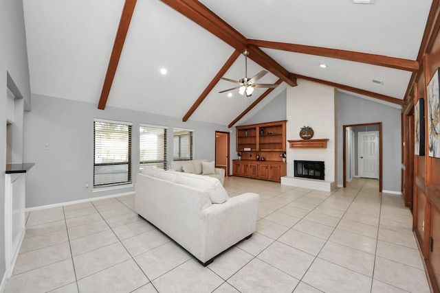 living room featuring light tile patterned floors, visible vents, a brick fireplace, beamed ceiling, and baseboards