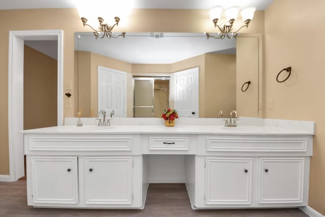 full bathroom with double vanity, a sink, and a notable chandelier