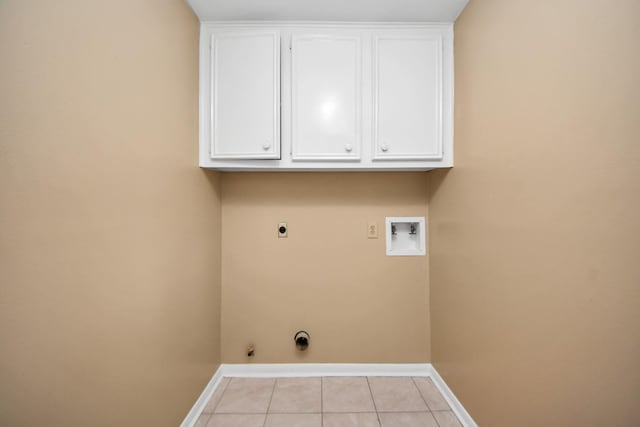 washroom featuring hookup for a washing machine, cabinet space, hookup for an electric dryer, light tile patterned flooring, and baseboards