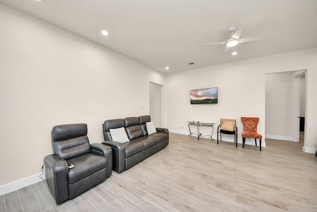 living area with light wood-style floors, recessed lighting, and baseboards