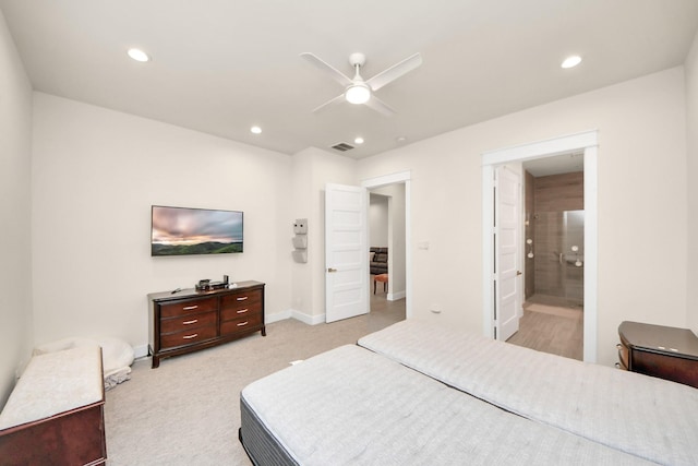 bedroom featuring light carpet, baseboards, ensuite bathroom, and recessed lighting